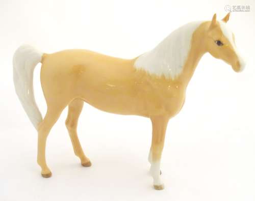 A Royal Doulton palomino horse, model number DA 55. Marked under. Approx. 6 1/2