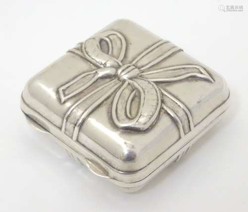 A novelty Greek silver box formed as a present / gift with ribbon decoration and opening to reveal