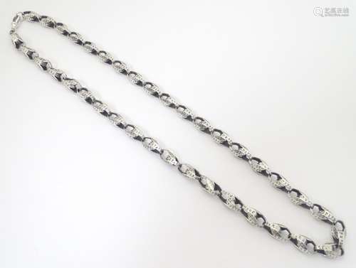 A silver long guard / necklace .