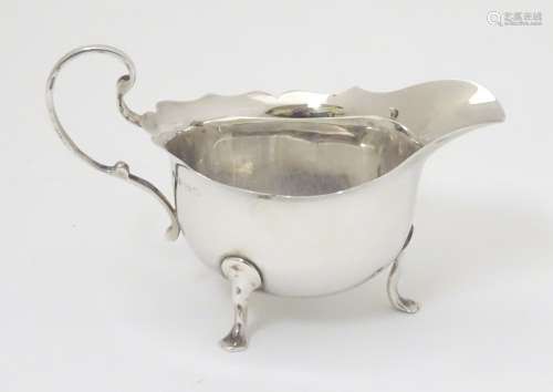 A small silver cream / sauce jug hallmarked Birmingham 1922 maker Adie Bros Ltd.