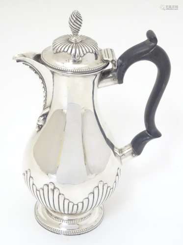 A Victorian silver coffee pot with ebonised handle. Hallmarked London 1875 maker Henry Holland.