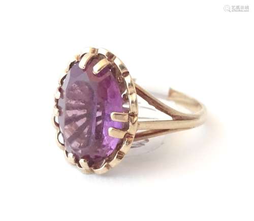 A 9ct gold ring set with oval amethyst, hallmarked Birmingham 1919, maker D & W. Ring size approx.