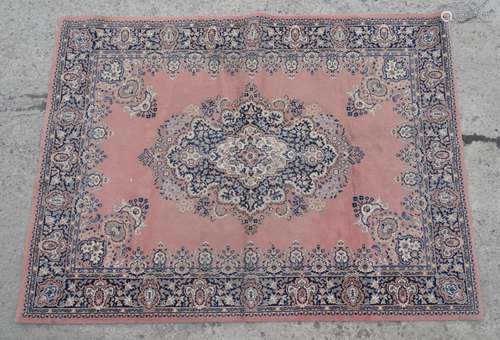 Carpet rug :a machine made pink ground small carpet with grey, black , buff and cream colours ,