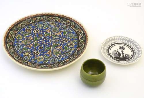 Three assorted ceramic items to include a charger with hand painted arabesque floral decoration,