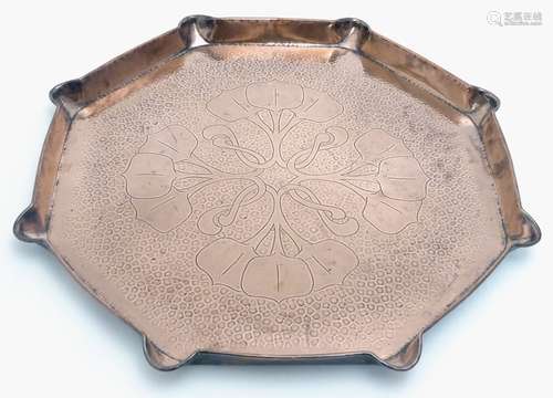 An Arts & Crafts octagonal copper charger / tray with incised natural form decoration and a shaped