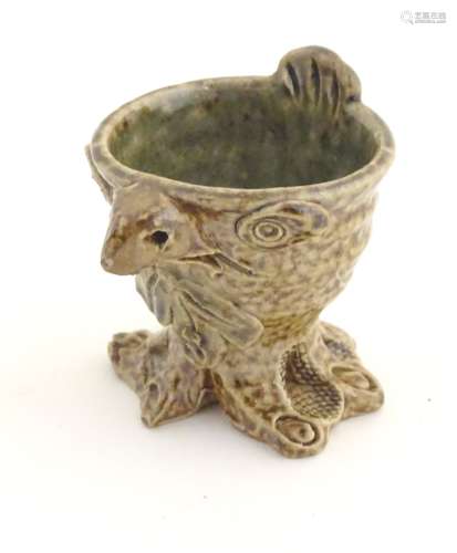 A novelty stoneware egg cup modelled in the style of a Martin Brothers' wally bird.