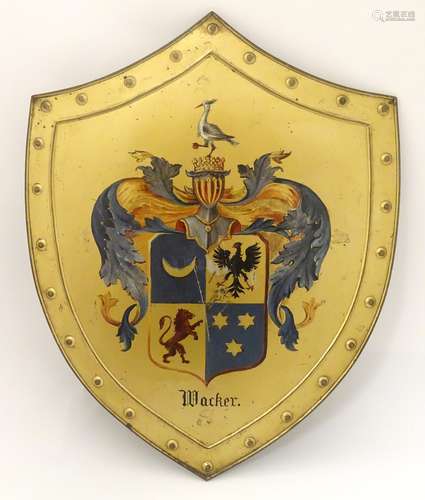 A 20thC tin plate heraldic shield wall plaque,