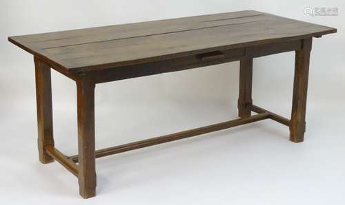 An early 20thC oak refectory / dining table with a large rectangular planked top above a single