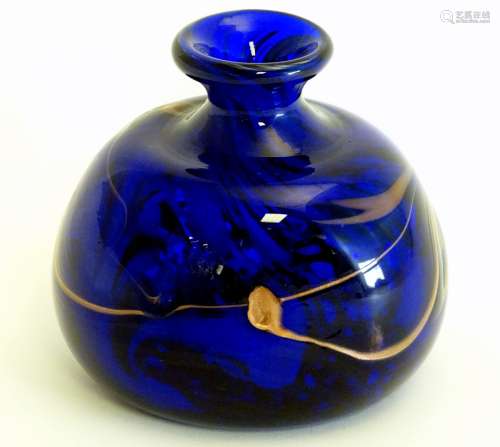 A studio glass vase with blue and bronze coloured swirl decoration.