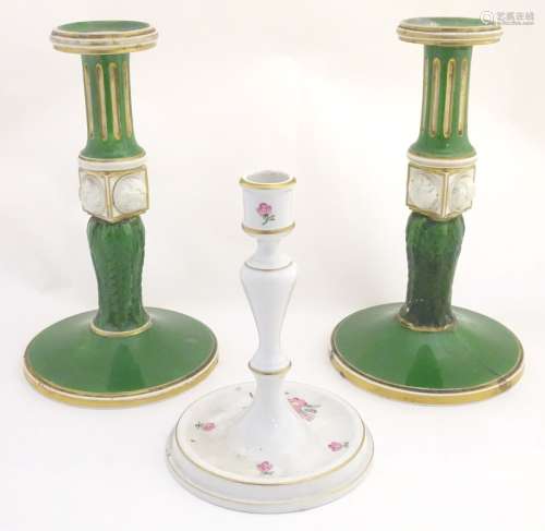 A pair of Bloor Derby candlesticks with acanthus and fluted columns with gilt highlights.