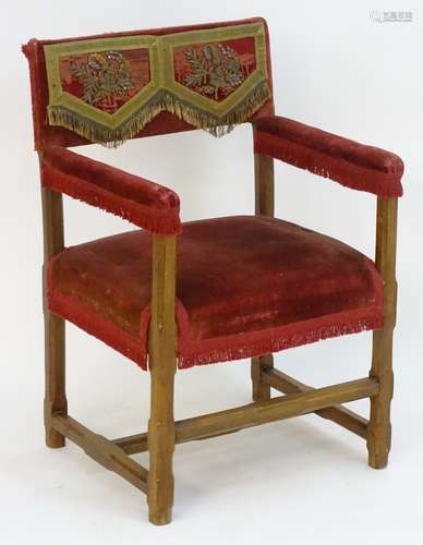 A 20thC open armchair with an upholstered backrest, seat and arms,