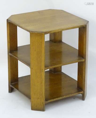 An Art Deco oak three tier table with four chamfered corner supports.