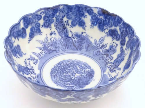 An Oriental bowl with a lobed rim, decorated with figures in a landscape. Approx.