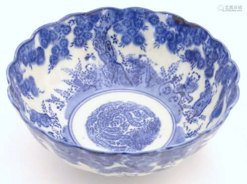 An Oriental bowl with a lobed rim, decorated with figures in a landscape. Approx.