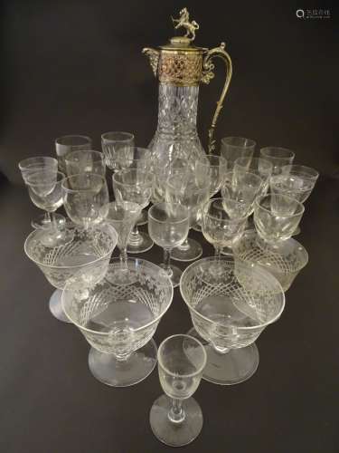 A quantity of assorted drinking glasses of various sizes together with a cut glass claret jug with