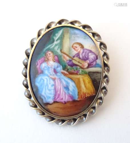 A silver gilt brooch set with hand painted ceramic cabochon depicting a 19thC interior scene.