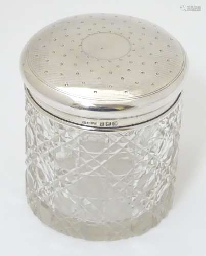 A cut glass dressing table jar with silver top hallmarked Birmingham 1915 maker S Blanckensee &