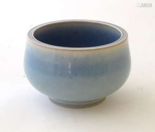An unmarked high fired blue glazed bowl.