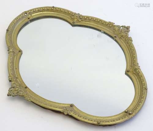 A 20thC Quatrefoil formed mirror with egg and dart moulded frame.