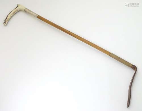 A 20thC antler handled riding crop with a malacca shaft and silver collar,