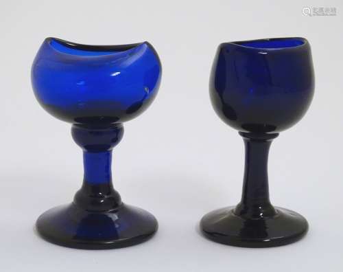 Two late 19th C blue glass pedestal eye baths. Tallest 3