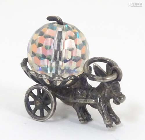 A novelty pendant charm formed as a donkey pulling a cart decorated with a facet cut bead.