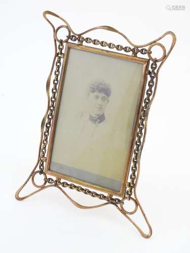 A Victorian brass picture frame with wirework decoration and an easel back support. Approx.