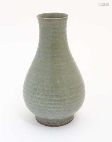 A Chinese celadon pear-shaped vase with a crackle glaze. Approx. 9 3/4
