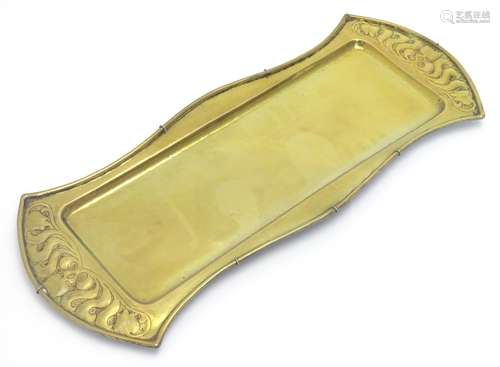 An Arts & Crafts brass oblong tray with embossed natural form decoration. Stamped W. H.