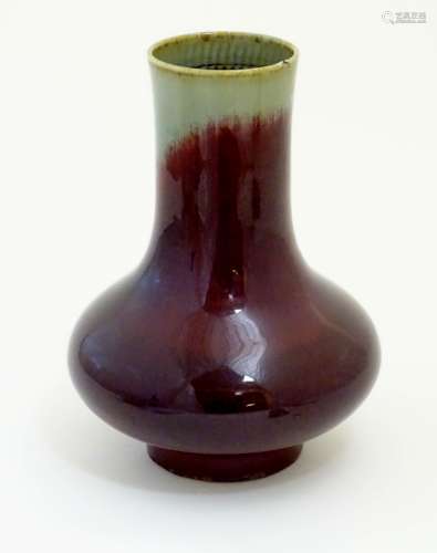 A Chinese sang de boeuf two tone vase with a crackle glaze. Character marks under. 11 1/2