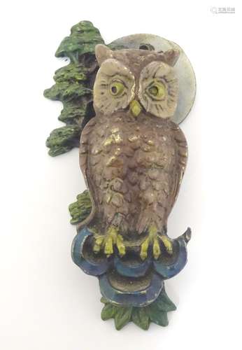 A 20thC painted brass door knocker formed as an owl with tree and moon decoration. Approx.