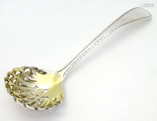 A silver sifter / caster spoon with gilded bowl hallmarked Birmingham 1913 maker barer Brothers