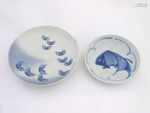 Two Japanese blue and white hand painted plates, one decorated with a fish,