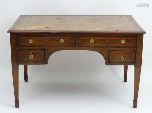 An early 20thC four drawer mahogany desk with an inset leather top,