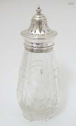 A cut glass sugar caster / mutineer with silver mounts and top Hallmarked Birmingham 1930 maker