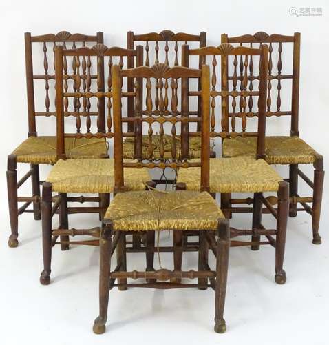 A set of six fruitwood spindle back chairs with carved cresting rails,