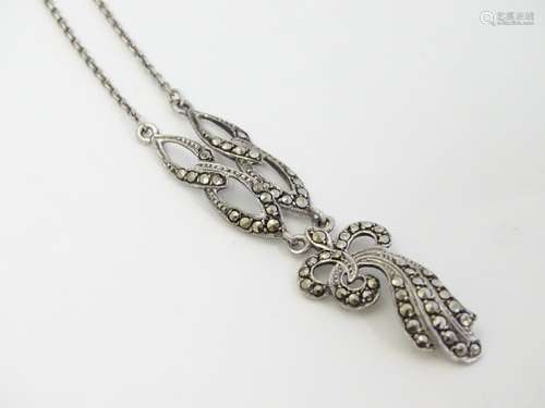 A silver necklace with pendant set with marcasite detail.