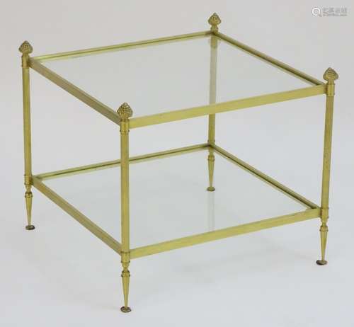 A 20thC two tier gilt brass and glass coffee table standing on turned tapering feet.