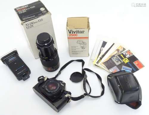 A late-20thC Nikon 'EM' SLR 35mm film camera, together with Vivitar telephoto lens and flash unit,