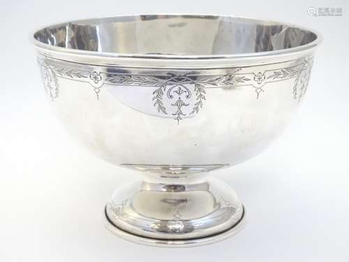 A large silver pedestal bowl with engraved decoration.