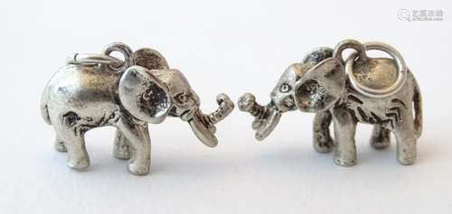 A pair of silver novelty pendant charms formed as elephants. Approx.