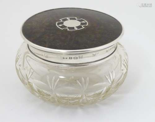 A cut glass dressing table pot with silver and tortoiseshell lid hallmarked Birmingham 1925 maker