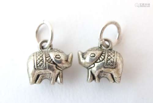 A pair of silver novelty pendant charms formed as elephants. Approx.