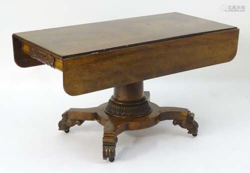 A mid 19thC mahogany centre table with drop flaps, carved ends and unusual carved sides,