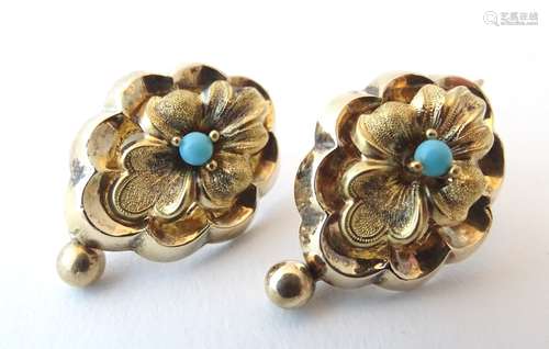 An ornate pair of 14ct gold drop earrings of stylised floral form set with central turquoise.