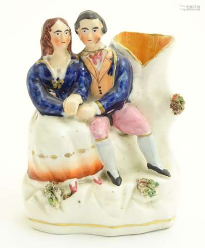 A Victorian Staffordshire pottery flatback spill vase depicting Victoria and Albert seated. Approx.
