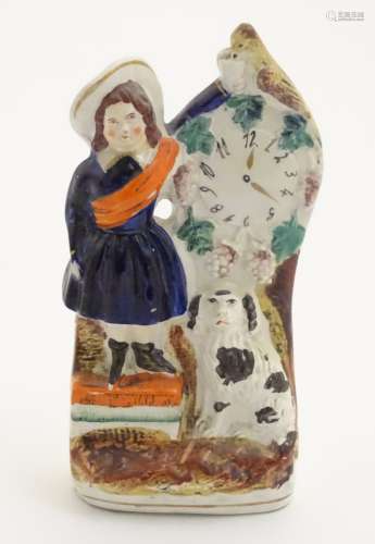 A Victorian Staffordshire pottery flatback model of a woman wearing a sash feeding a bird next to a