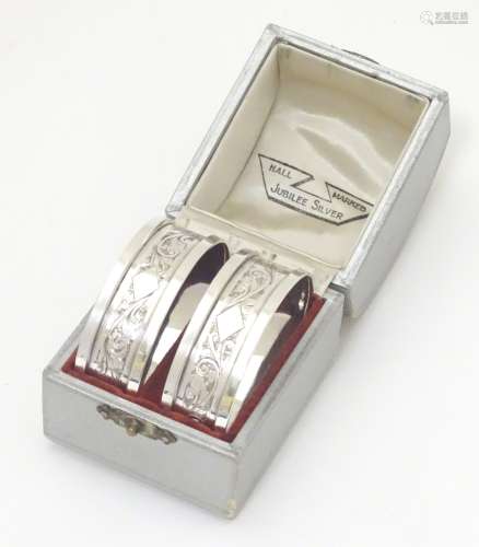 A cased pair of silver napkin rings Hallmarked Birmingham 1934 with silver jubilee mark maker