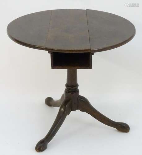 A late 18thC oak tripod table with a birdcage movement and book compartment to the underside of the