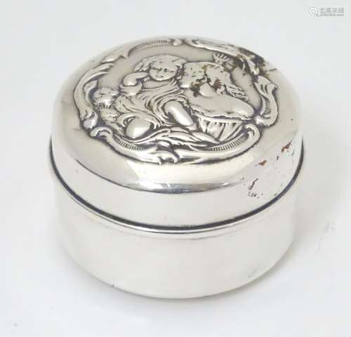 A silver pot and cover with embossed scene to lid.